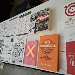 Books and flyers on the Turn the Tables conference table